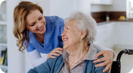 nurse smiling at elderly patient